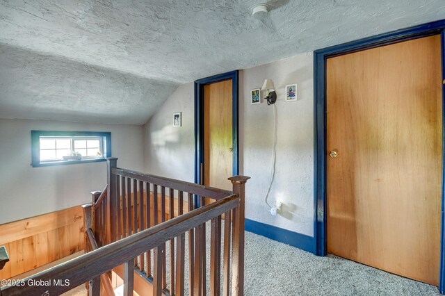 1330 State Highway 67, Johnstown, NY 12095 - hall featuring an upstairs landing, a textured ceiling, carpet floors, and vaulted ceiling