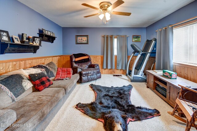 1330 State Highway 67, Johnstown, NY 12095 - living room with wooden walls, wainscoting, ceiling fan, and carpet floors