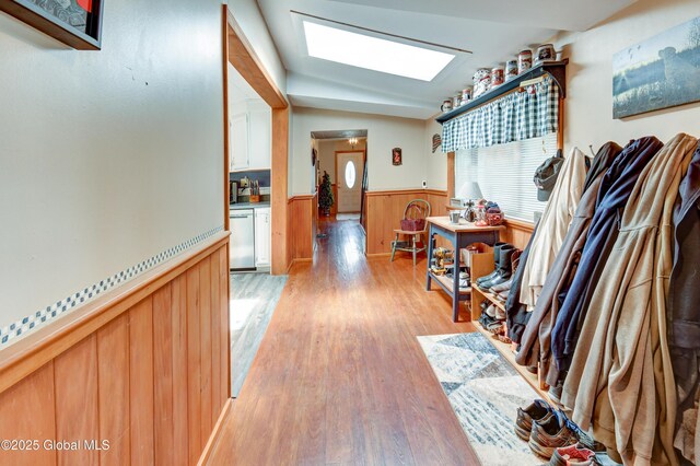 1330 State Highway 67, Johnstown, NY 12095 - hall with wainscoting, light wood-style flooring, a skylight, and wood walls