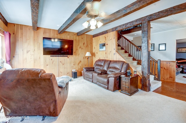 1330 State Highway 67, Johnstown, NY 12095 - living area featuring beamed ceiling, stairs, wooden walls, a ceiling fan, and carpet floors