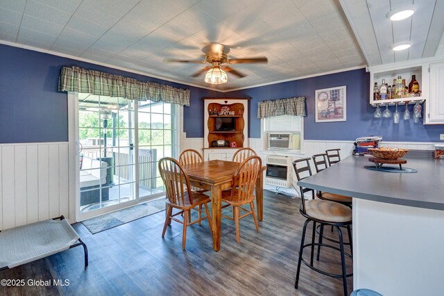 1330 State Highway 67, Johnstown, NY 12095 - dining area with wainscoting, a ceiling fan, dark wood-style flooring, cooling unit, and ornamental molding