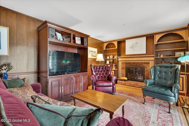 62 Pheasant Ridge Dr, Colonie, NY 12211 - living area with wooden walls, wood finished floors, a fireplace, and built in shelves