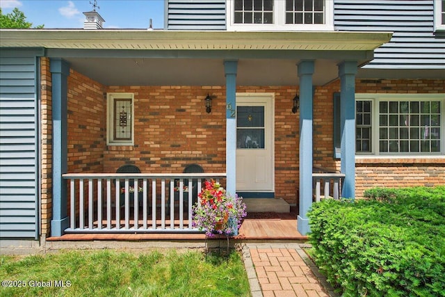 62 Pheasant Ridge Dr, Colonie, NY 12211 - view of exterior entry with a porch and brick siding