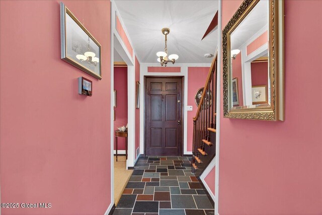 62 Pheasant Ridge Dr, Colonie, NY 12211 - foyer entrance with a chandelier, ornamental molding, dark stone finish floors, and stairway