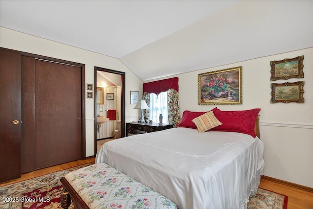 62 Pheasant Ridge Dr, Colonie, NY 12211 - bedroom with vaulted ceiling, wood finished floors, and connected bathroom
