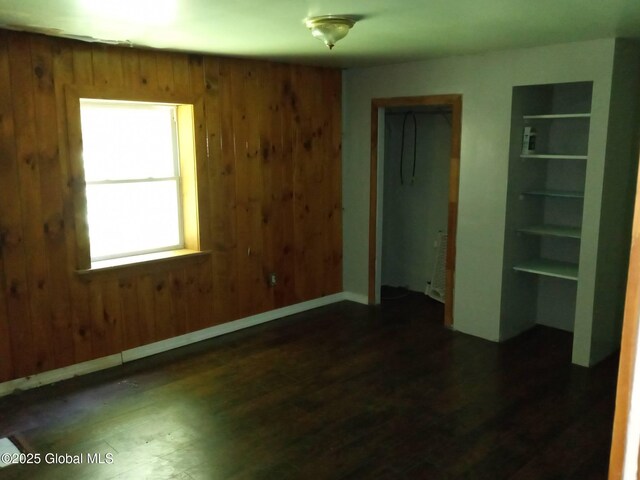 3190 State Highway 10, Johnstown, NY 12095 - unfurnished bedroom featuring wood finished floors, wooden walls, and a closet