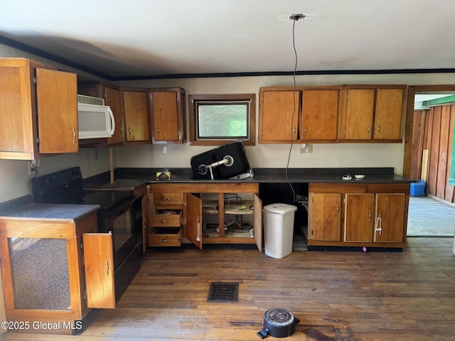 3190 State Highway 10, Johnstown, NY 12095 - kitchen featuring black electric range, white microwave, and brown cabinetry