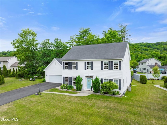 14 Maplecrest Dr, Ravena, NY 12143 - colonial inspired home featuring a garage and a front yard