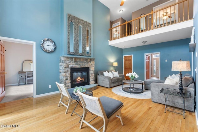 14 Maplecrest Dr, Ravena, NY 12143 - living area with a towering ceiling, wood finished floors, a stone fireplace, and ceiling fan
