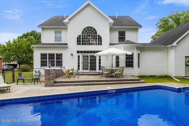 14 Maplecrest Dr, Ravena, NY 12143 - rear view of house featuring an outdoor pool, a patio area, a shingled roof, and outdoor dining space