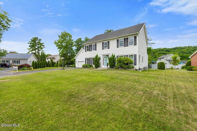 14 Maplecrest Dr, Ravena, NY 12143 - colonial house with driveway, a front yard, and a garage