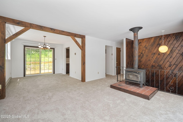 257 Lake Rd, Cobleskill, NY 12043 - unfurnished living room with a wood stove, a chandelier, and carpet