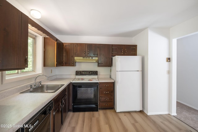 257 Lake Rd, Cobleskill, NY 12043 - kitchen featuring range with electric stovetop, freestanding refrigerator, under cabinet range hood, dishwasher, and light wood finished floors