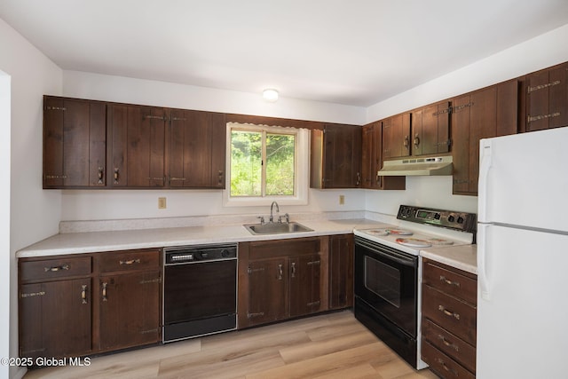 257 Lake Rd, Cobleskill, NY 12043 - kitchen with freestanding refrigerator, black dishwasher, electric range oven, under cabinet range hood, and dark brown cabinetry