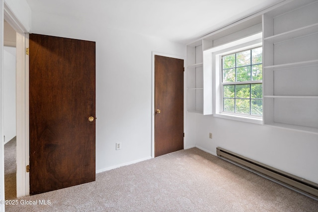 257 Lake Rd, Cobleskill, NY 12043 - unfurnished bedroom featuring a baseboard heating unit and carpet