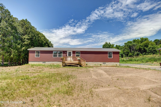 135 Lafayette St, Palatine Bridge, NY 13428 - view of front of house with crawl space, a deck, dirt driveway, and a metal roof