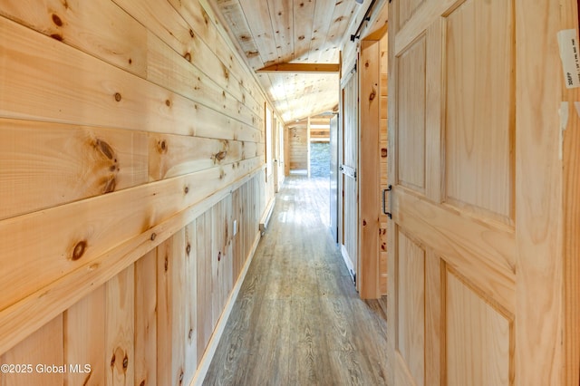 135 Lafayette St, Palatine Bridge, NY 13428 - hall with lofted ceiling, wood ceiling, wood finished floors, wooden walls, and a barn door