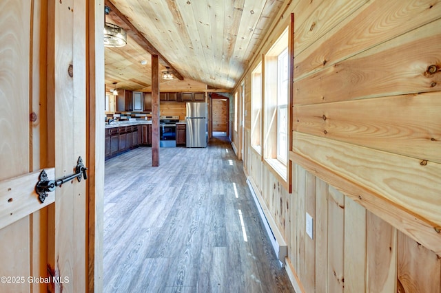 135 Lafayette St, Palatine Bridge, NY 13428 - corridor with vaulted ceiling, light wood finished floors, a baseboard heating unit, and wooden ceiling