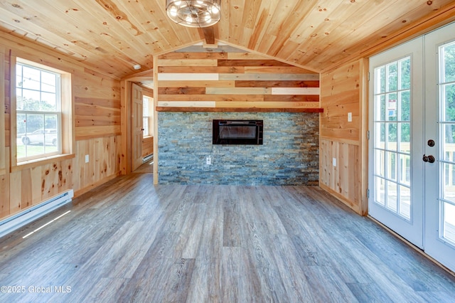 135 Lafayette St, Palatine Bridge, NY 13428 - unfurnished living room featuring wooden walls, plenty of natural light, lofted ceiling, wood ceiling, and a stone fireplace