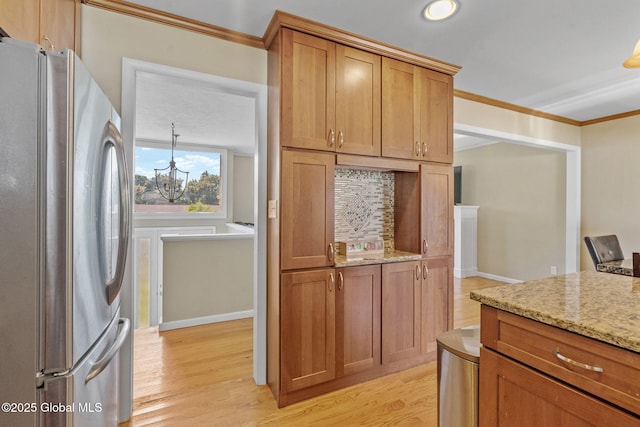 1 Tamarack Ln, East Greenbush, NY 12061 - kitchen with freestanding refrigerator, a chandelier, ornamental molding, light wood-style flooring, and light stone counters