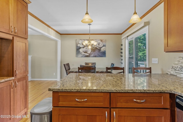 1 Tamarack Ln, East Greenbush, NY 12061 - kitchen featuring light stone counters, wood finished floors, hanging light fixtures, a peninsula, and brown cabinetry