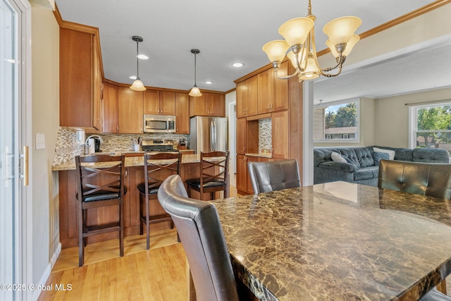 1 Tamarack Ln, East Greenbush, NY 12061 - dining room featuring light wood-style floors, a chandelier, recessed lighting, and crown molding