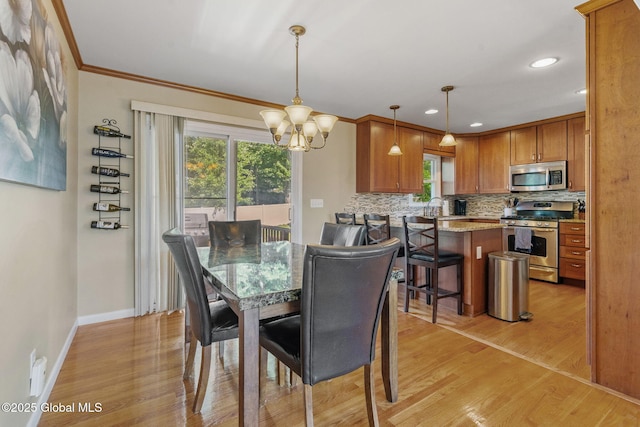1 Tamarack Ln, East Greenbush, NY 12061 - dining area with light wood-style flooring, a chandelier, crown molding, and recessed lighting