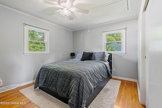 1 Tamarack Ln, East Greenbush, NY 12061 - bedroom featuring attic access, multiple windows, light wood-type flooring, ornamental molding, and a ceiling fan
