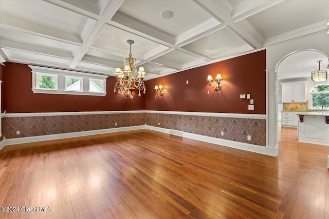 176 5th Ave, Saratoga Springs, Inside, NY 12866 - unfurnished room featuring light wood-style flooring, a wainscoted wall, coffered ceiling, beamed ceiling, and a chandelier