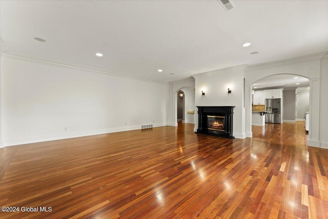 176 5th Ave, Saratoga Springs, Inside, NY 12866 - unfurnished living room with arched walkways, ornamental molding, wood finished floors, a glass covered fireplace, and recessed lighting
