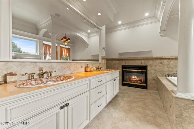 176 5th Ave, Saratoga Springs, Inside, NY 12866 - bathroom with crown molding, double vanity, tiled bath, a glass covered fireplace, and decorative columns