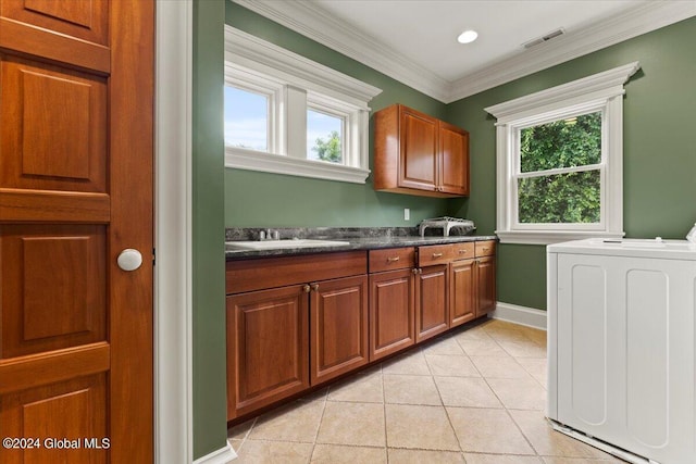 176 5th Ave, Saratoga Springs, Inside, NY 12866 - kitchen with washer / clothes dryer, dark countertops, light tile patterned flooring, brown cabinetry, and ornamental molding