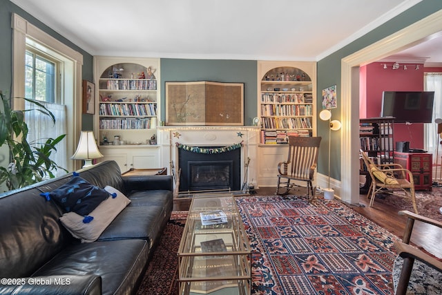 8 Front St, Schenectady, NY 12305 - living area with built in features, a glass covered fireplace, wood finished floors, and crown molding