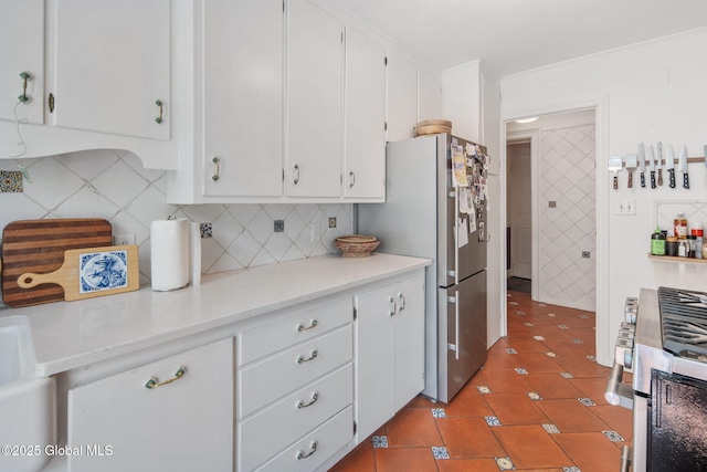 8 Front St, Schenectady, NY 12305 - kitchen with appliances with stainless steel finishes, white cabinetry, tile patterned flooring, decorative backsplash, and light countertops