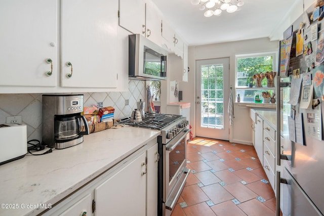 8 Front St, Schenectady, NY 12305 - kitchen with stainless steel appliances, tasteful backsplash, white cabinets, and light stone countertops