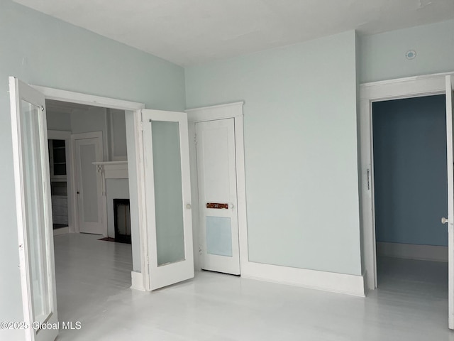 302-304 Quail St, Albany, NY 12208 - unfurnished bedroom featuring concrete flooring and a fireplace with flush hearth