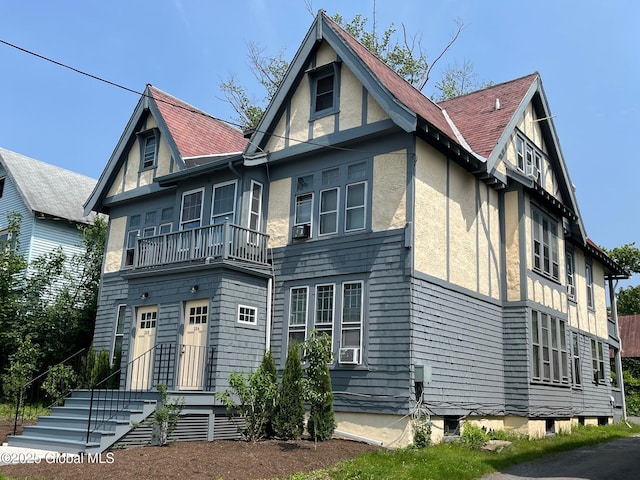 302-304 Quail St, Albany, NY 12208 - view of front facade with stucco siding, cooling unit, and a shingled roof