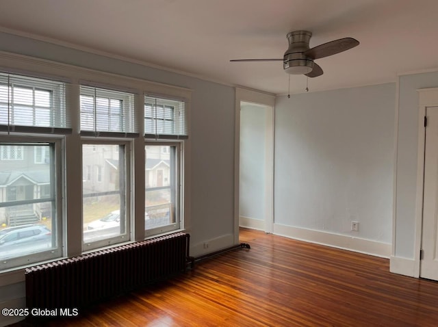 302-304 Quail St, Albany, NY 12208 - spare room featuring radiator heating unit, wood finished floors, and a ceiling fan