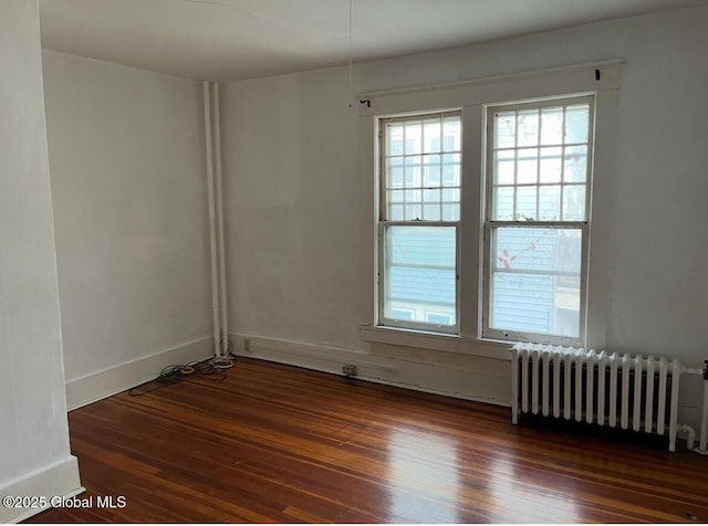 302-304 Quail St, Albany, NY 12208 - unfurnished room featuring radiator, plenty of natural light, and wood-type flooring