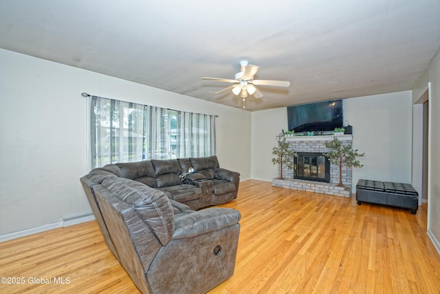 1101 Manas Dr, Schenectady, NY 12303 - living area with wood finished floors, ceiling fan, a fireplace, and a baseboard radiator