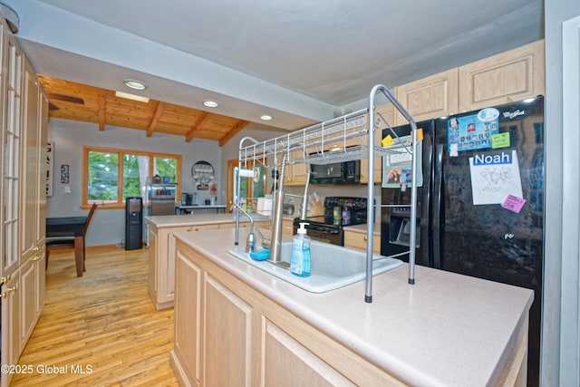 1101 Manas Dr, Schenectady, NY 12303 - kitchen featuring black appliances, light wood finished floors, recessed lighting, light brown cabinets, and light countertops