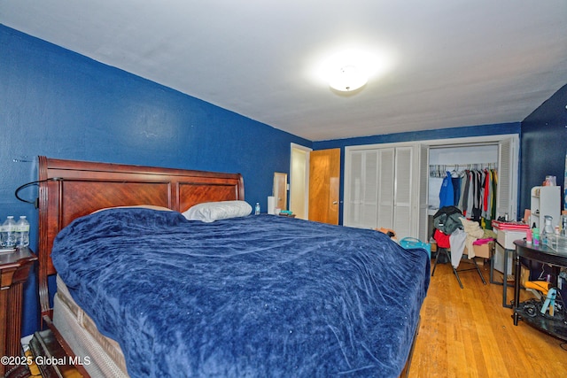 1101 Manas Dr, Schenectady, NY 12303 - bedroom featuring wood finished floors, multiple closets, and a textured wall