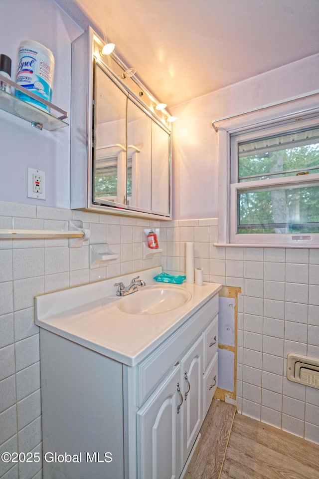 1101 Manas Dr, Schenectady, NY 12303 - bathroom featuring tile walls, vanity, wood finished floors, and a wainscoted wall