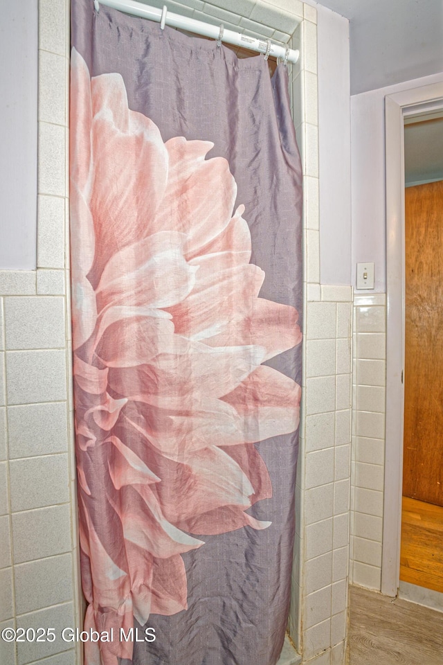 1101 Manas Dr, Schenectady, NY 12303 - bathroom with wood finished floors and tile walls