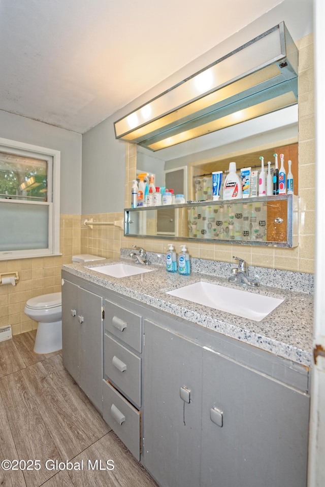 1101 Manas Dr, Schenectady, NY 12303 - full bath with tile walls, double vanity, and wood finished floors