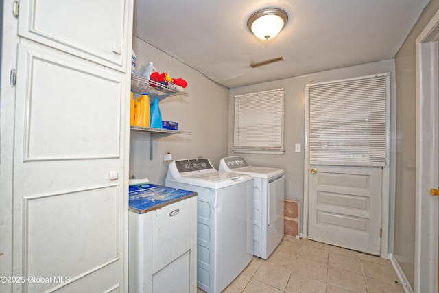 1101 Manas Dr, Schenectady, NY 12303 - laundry room with washing machine and clothes dryer and light tile patterned floors