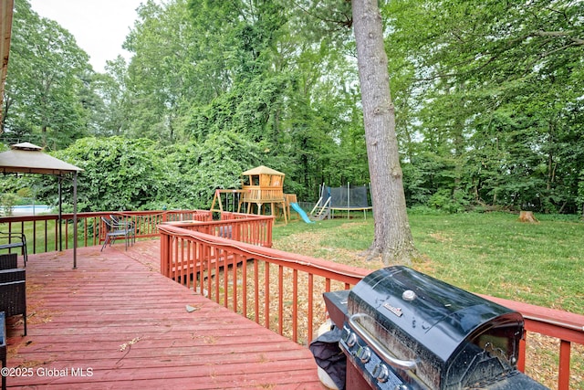 1101 Manas Dr, Schenectady, NY 12303 - wooden terrace with grilling area, a trampoline, a playground, a yard, and a gazebo