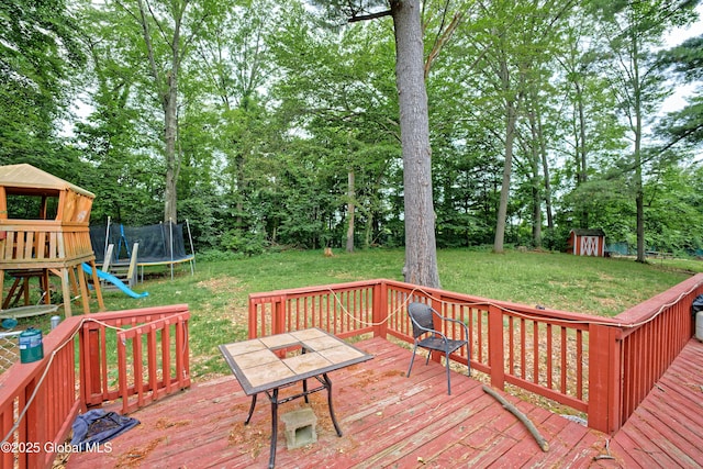 1101 Manas Dr, Schenectady, NY 12303 - wooden deck featuring a trampoline, a storage shed, a yard, and view of scattered trees