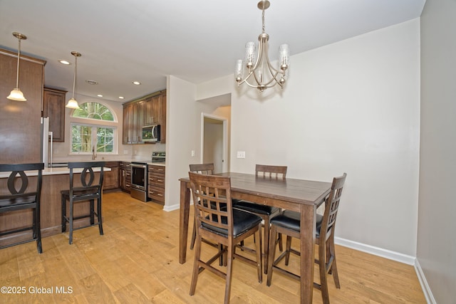 614 Apex Ln, Troy, NY 12182 - dining area featuring a chandelier, light wood finished floors, and recessed lighting