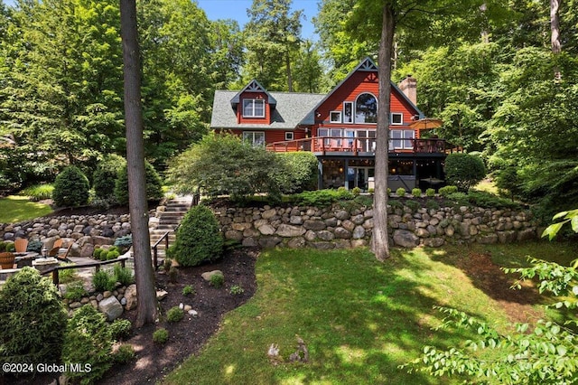 15 Green Harbour Ln, Lake George, NY 12845 - back of property featuring a chimney, a wooden deck, stairs, and a yard